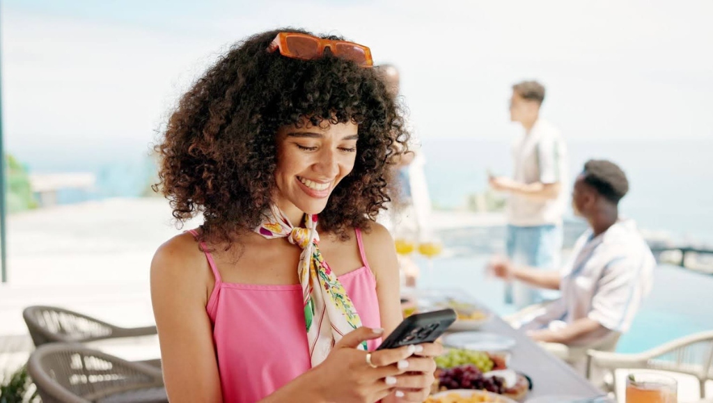 Happy woman using a phone to decide on party planning ideas