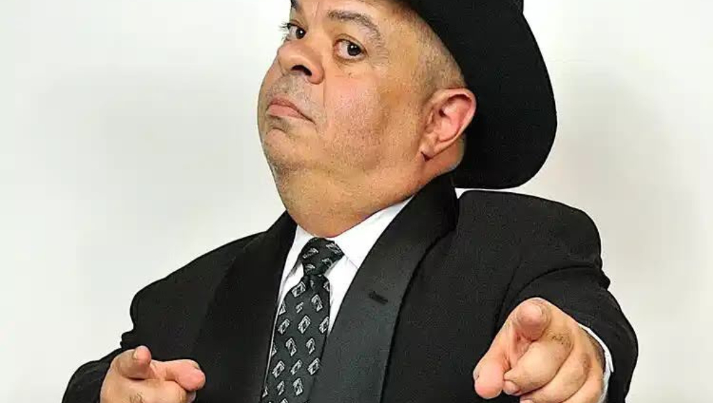 Little person entertainer pointing forward, dressed to host your next big event